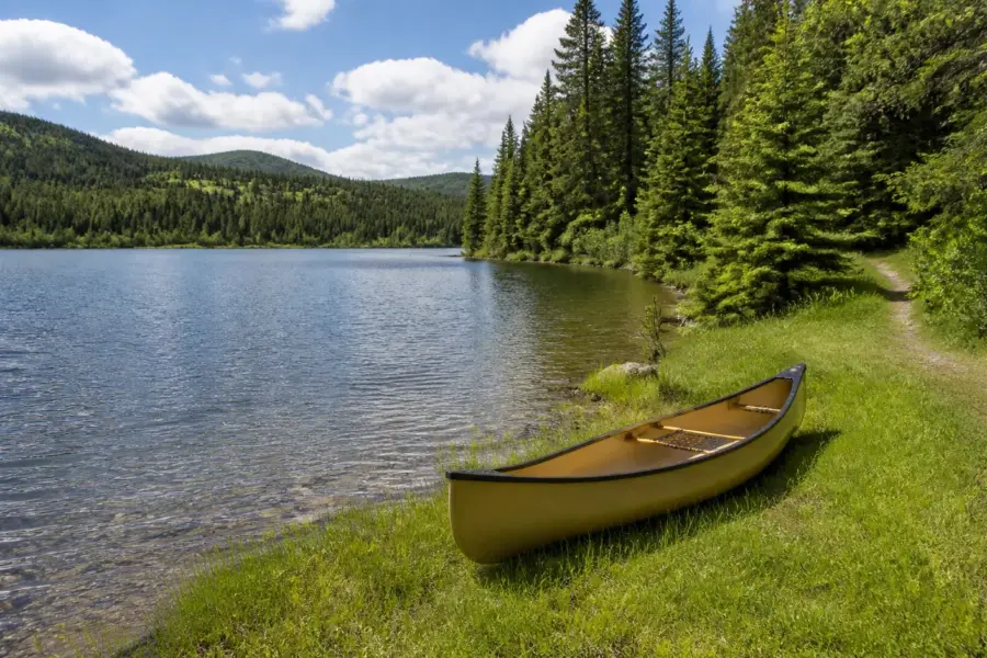 A canoe waiting on the shore of Kibbee Lake at the end of the walk-in trail