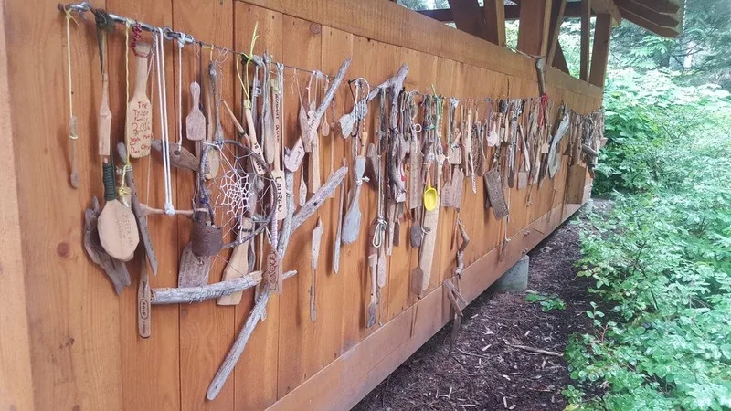 A wall of paddles and driftwood found on the circuit, displayed at the Registration Centre