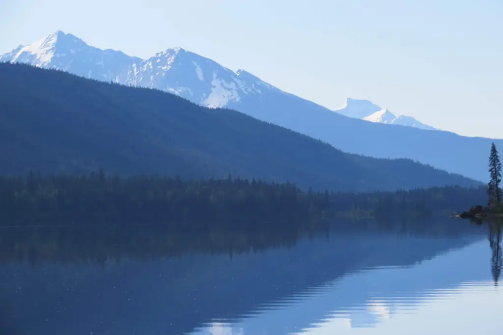 Snow-capped Cariboo peaks reflected in still water on the circuit