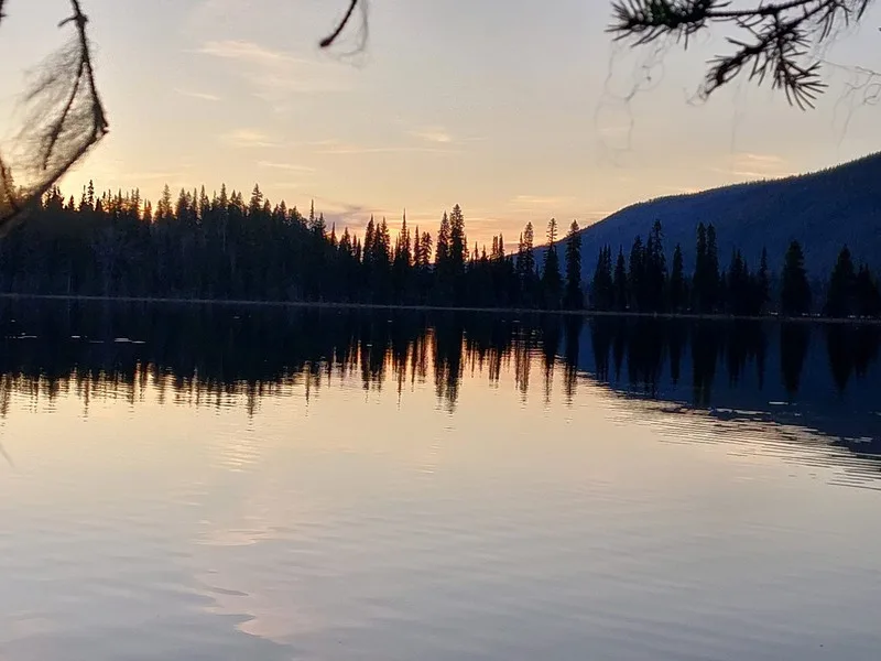 Sunset over a still lake on the Bowron Lake Canoe Circuit